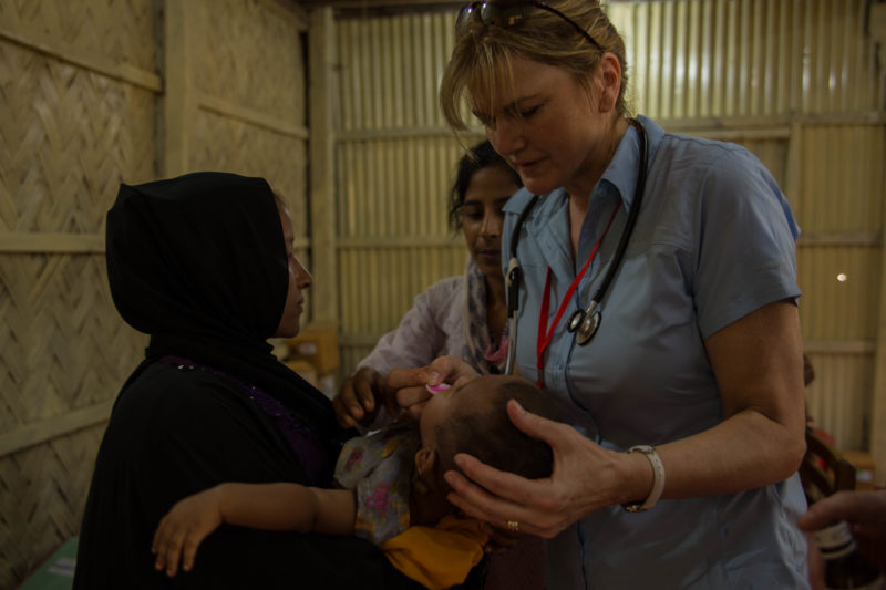 Nurse Theresa Wood cares for a mother and baby at Medical Teams' diarrhea management clinic at the Kutupalong settlement in Bangladesh