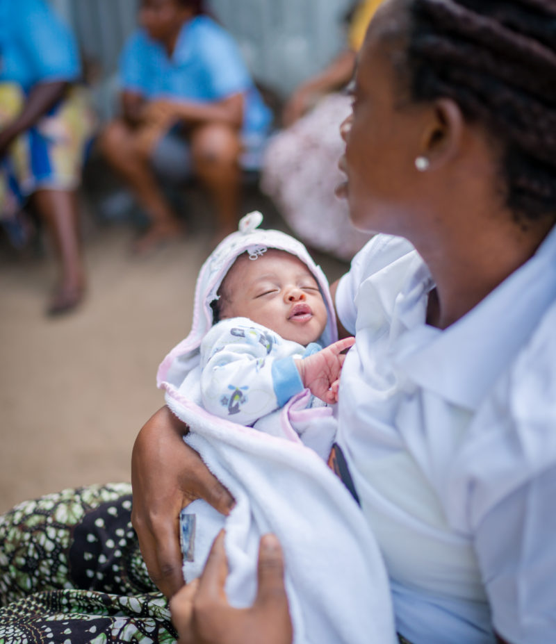 Abigail, a Liberian woman, holding her newborn daughter, Miracle