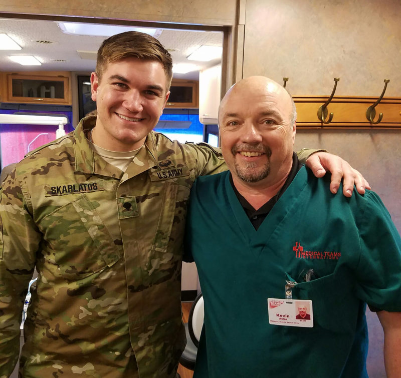 Alek Skarlatos and Mobile Dental Clinic Manager Kevin Abbe, pose together aboard a van in Southern Oregon