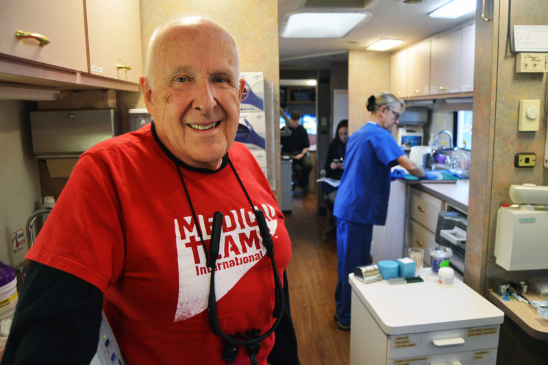 Dr. Dale Canfield volunteering in one of the mobile dental vans at a mobile dental clinic in Portland, Ore