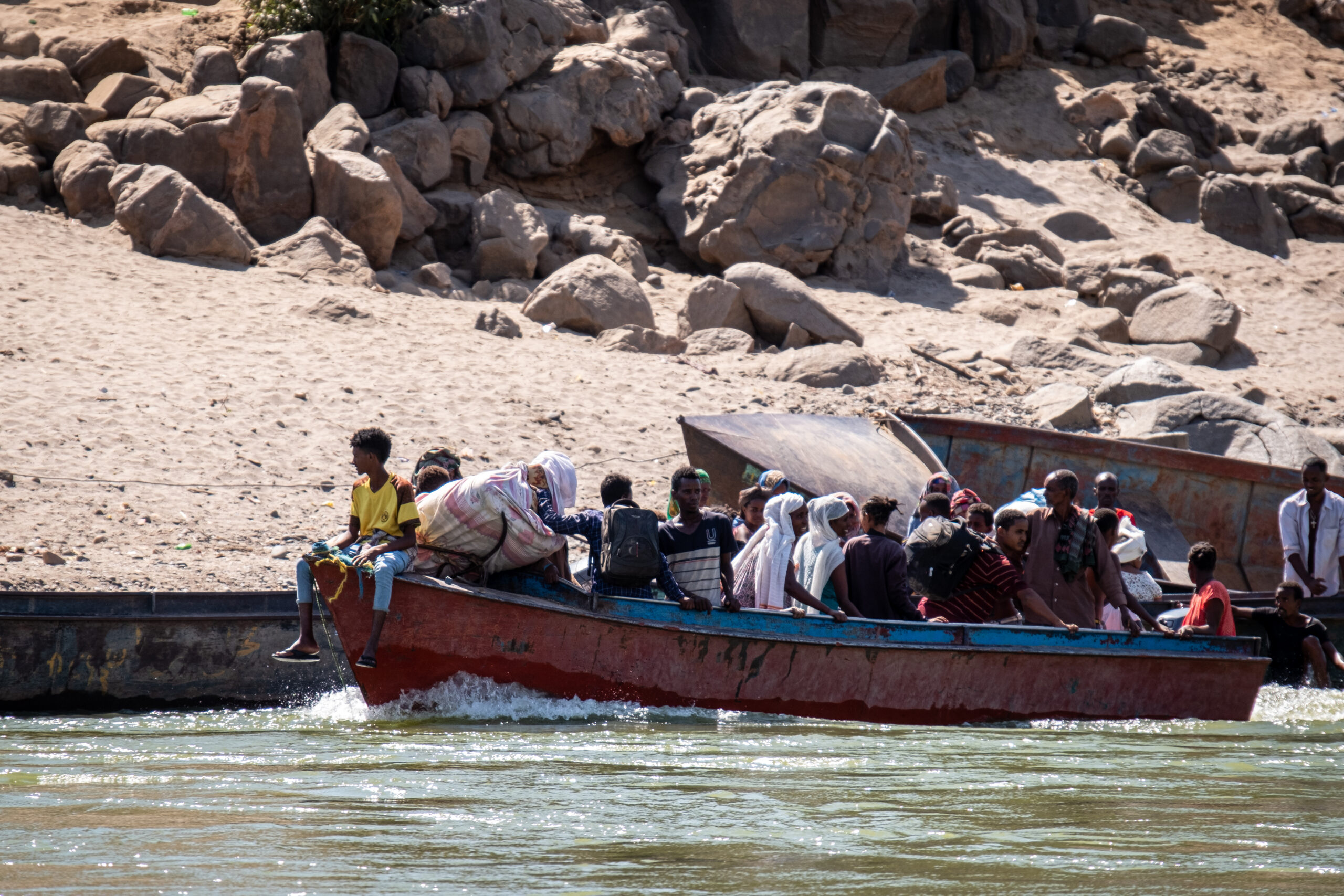 Ethiopian refugees crossing the Tekeze River in a boat. Photo by Joost Bastmeijer.